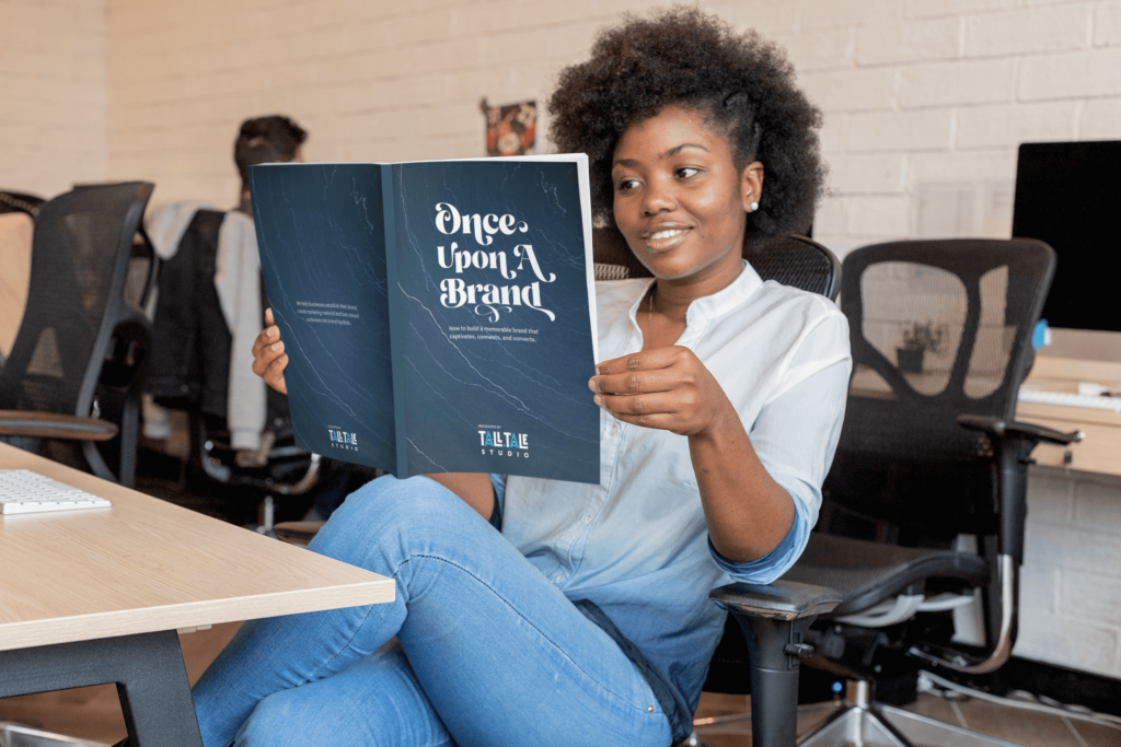 Woman reviewing printed brand guide.